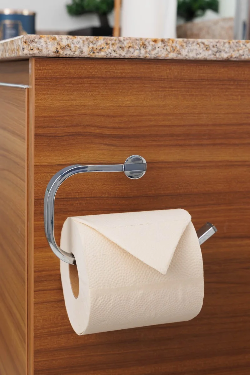 Warm ivory Skid Slayer paper with dotted embossing and a brown hollow core on a bathroom holder